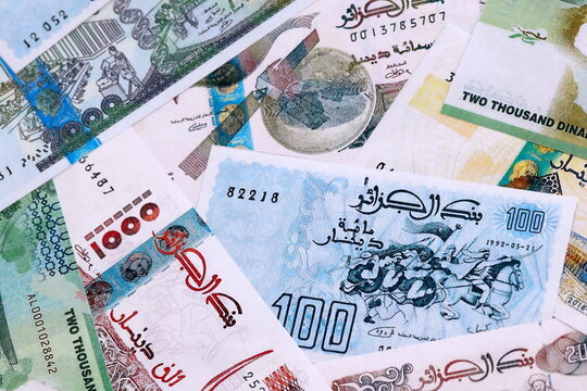 Algerian dinar money bills pile on table. Algeria banknotes of DZD currency close up.