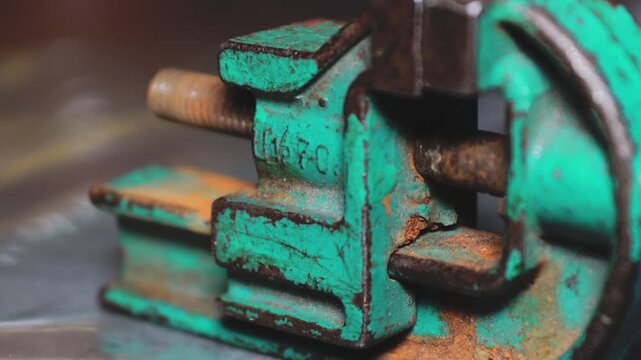 Close-up shot of a clamp attached to a metal surface, suitable for industrial or mechanical context