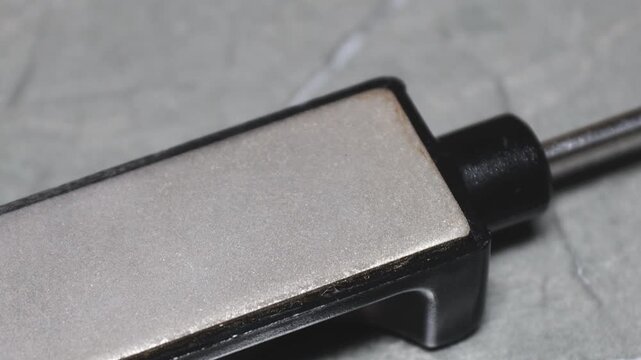 A close-up view of a cell phone lying on a table, with the screen and buttons visible