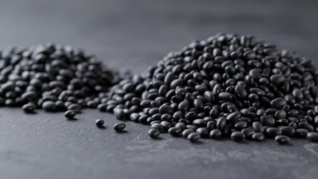  Heap of Black beans (black gram ) on a dark table. Organic black beans.