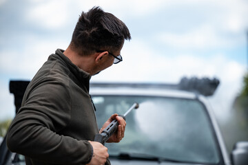 Man washing car using pressure washer outdoors © Zoran Jesic