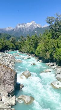 Hornopir&eacute;n, Chile - March 20, 2026: The Blanco River, with its turquoise waters, flows through the lush nature of Chilean Patagonia. The majestic Cerro Cholila can be seen in the mountains.