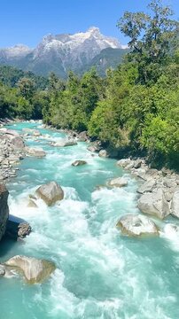Hornopir&eacute;n, Chile - March 20, 2026: The Blanco River, with its turquoise waters, flows through the lush nature of Chilean Patagonia. The majestic Cerro Cholila can be seen in the mountains.