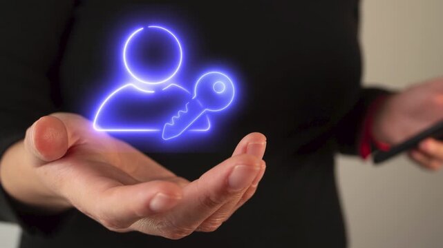 Businesswoman's hand holding an icon of a person with a key