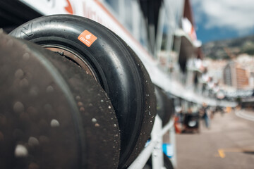 Fototapeta premium Racing tires stacked in motorsport paddock at race circuit