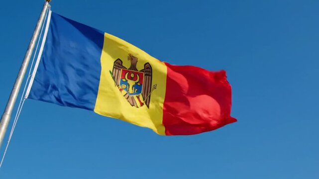 The national flag of moldova waving against a clear blue sky