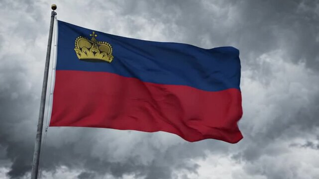 The national flag of liechtenstein waving against a dramatic, cloudy sky