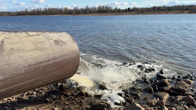 Wastewater discharge from pipe into river water, environmental pollution and contamination, dirty sewage flowing into nature