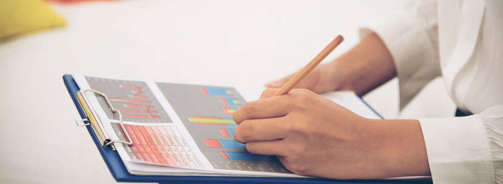 Banner Asian entrepreneur business woman reading business graph analyze chart using laptop on green garden at home. Hands Protect Debt loan home financial plan coin stack. Banner Closeup businessman