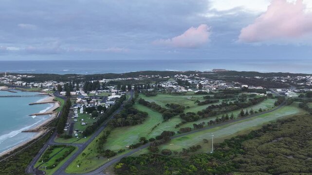 Sunrise over Beachport, South Australia: 4K aerial drone footage of coastal town, low density houses, estates, jetty, calm ocean, Southern Ocean Beach and golden morning light.