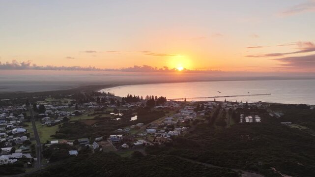 Beachport, South Australia at sunrise: 4K aerial drone footage of coastal town, jetty, calm ocean, Southern Ocean Beach and golden morning light