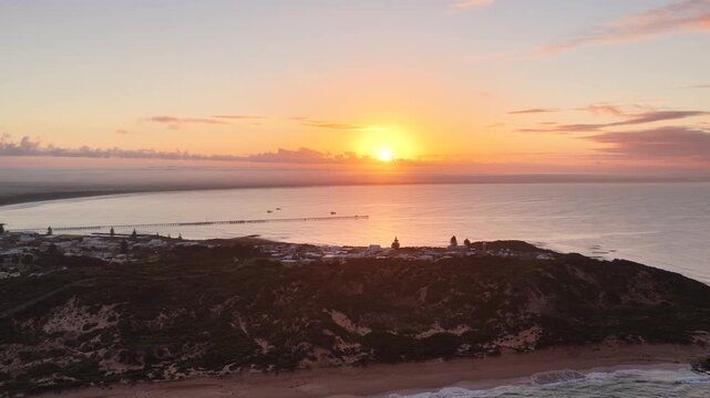 Beachport, South Australia at sunrise: 4K aerial drone footage of coastal town, jetty, calm ocean, Southern Ocean Beach and golden morning light
