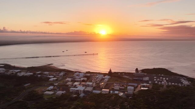 Beachport, South Australia at sunrise: 4K aerial drone footage of coastal town, jetty, calm ocean, Southern Ocean Beach and golden morning light