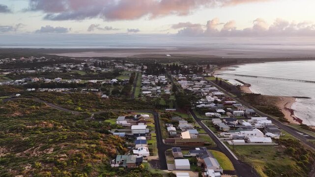 Beachport, South Australia at sunrise: 4K aerial drone footage of coastal town, jetty, calm ocean, Southern Ocean Beach and golden morning light
