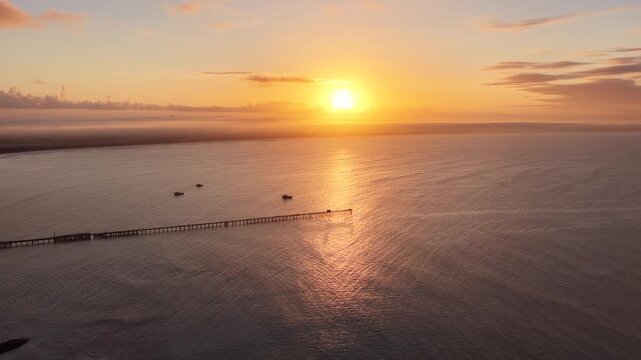 Beachport, South Australia at sunrise: 4K aerial drone footage of coastal town, jetty, calm ocean, Southern Ocean Beach and golden morning light