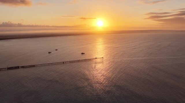 Beachport, South Australia at sunrise: 4K aerial drone footage of coastal town, jetty, calm ocean, Southern Ocean Beach and golden morning light