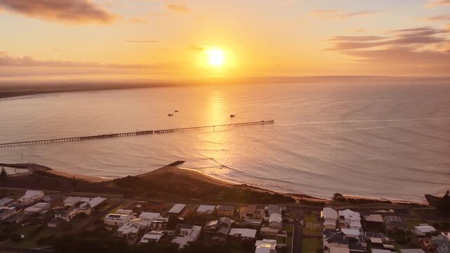Beachport, South Australia at sunrise: 4K aerial drone footage of coastal town, jetty, calm ocean, Southern Ocean Beach and golden morning light