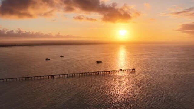 Beachport, South Australia at sunrise: 4K aerial drone footage of coastal town, jetty, calm ocean, Southern Ocean Beach and golden morning light