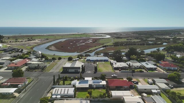Kingston SE, South Australia: 4K aerial drone footage of coastal town, river mouth, wetland, mangrove, residential houses, estates, streets, local traffic, and seaside landscape.