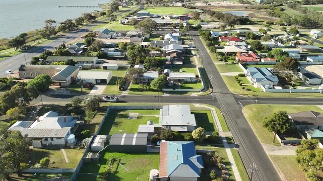 Meningie, South Australia: 4K aerial drone footage of Lake Albert, waterfront township, marina, houses, residential estates, streets, traffic, wetlands and riverside landscape
