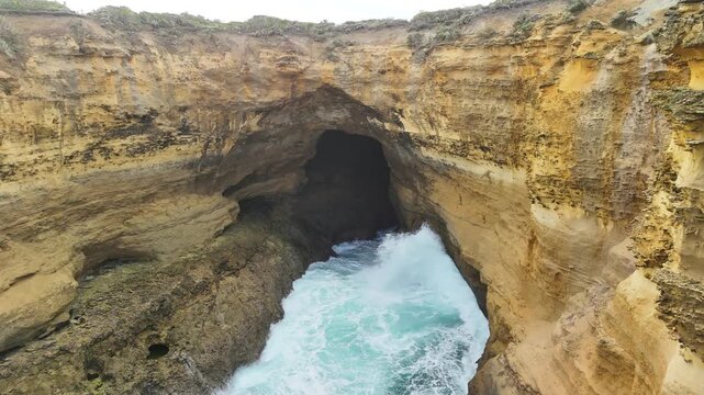 Thunder Cave and Mutton Bird Island, Great Ocean Road, Port Campbell, Victoria, Australia: 4K aerial drone footage of sea cave, cliffs and ocean waves