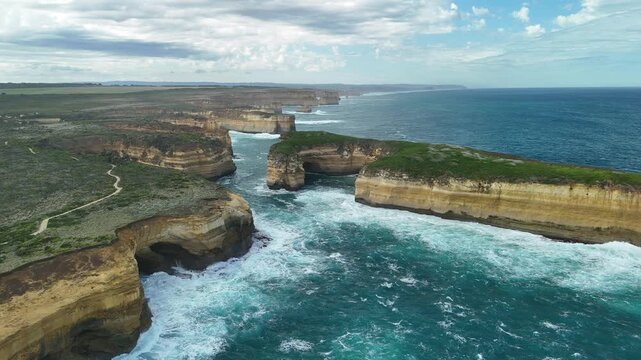 Thunder Cave and Mutton Bird Island, Great Ocean Road, Port Campbell, Victoria, Australia: 4K aerial drone footage of sea cave, cliffs and ocean waves