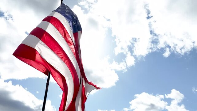 United States Flag Blowing Dramatically in the Wind on a Bright Cloudy Day