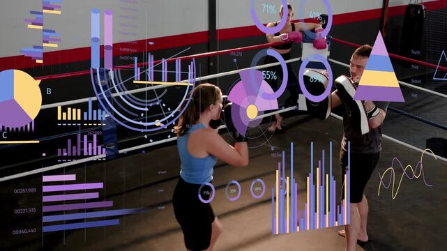 Female boxer starting drill, stepping, throwing jabs while male coach angling pads, charts updating