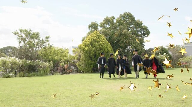 Seven grads walking toward camera to pose for graduation, caps and gold star drifting across frame