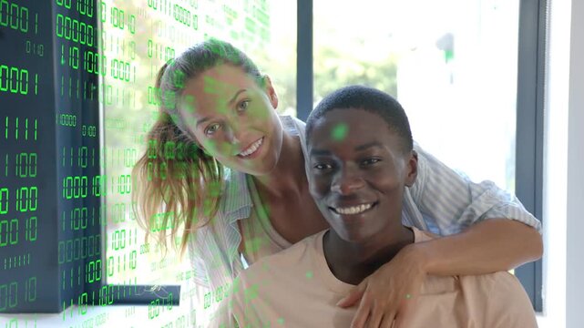 Woman coming leaning over man's shoulder, hand on chest, evoking smiles as tech binary casting left