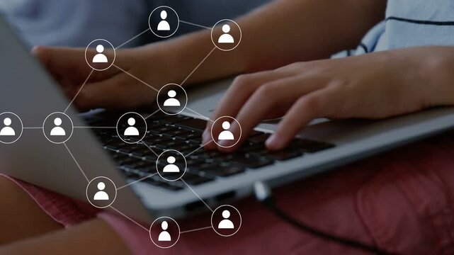 Boy typing on laptop, causing network nodes emerging and linking across hands, showing tech