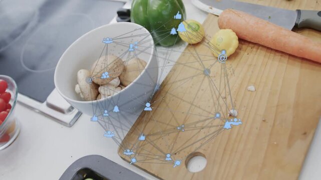 Camera panning right, cutting board and knife moving center while AR tracking produce to show prep