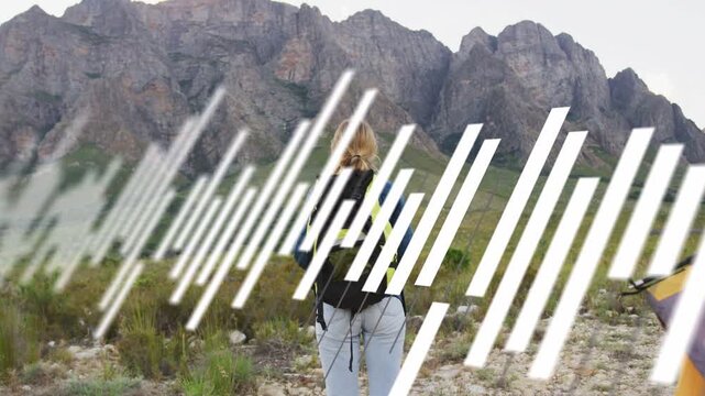 Woman leaning, stepping to ridge, adjusting straps, hiking to camp, bars sweeping, obscuring her