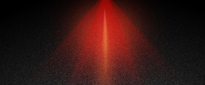 Red beam of light shining upwards from a textured dark background, creating a vibrant, glowing, and sparkling abstract pattern that suggests magic and energy