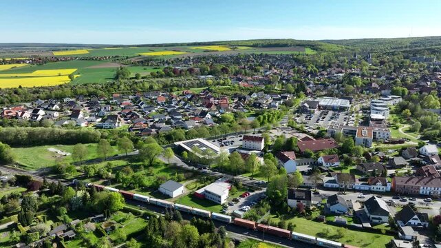 Aerial drone footage of K&ouml;nigslutter am Elm in Helmstedt district, Germany with slow movement over residential neighborhood and small town landscape