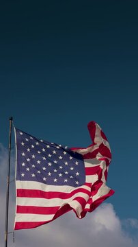 Vertical Seamless Loop of American Flag Waving with Copy Space