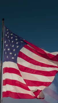 Vertical Seamless Loop of American Flag Waving with Copy Space