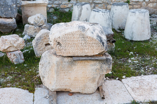 Ancient inscribed stone blocks resting on wooden supports