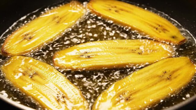 Yellow Plantain Slice Into Frying Pan With Hot Bubbling Oil