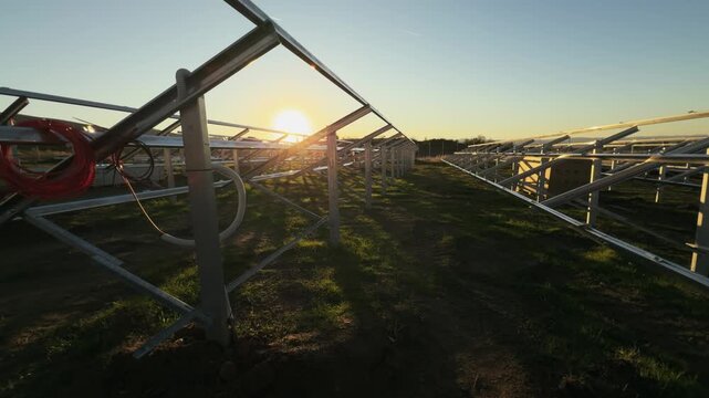Photovoltaic Power Plant Construction Frames at Sunset