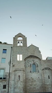Historic Church of Ognissanti Trani Italy with Birds Flying
