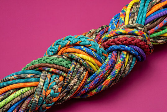 Intertwined bundle of colorful paracords on a bright surface