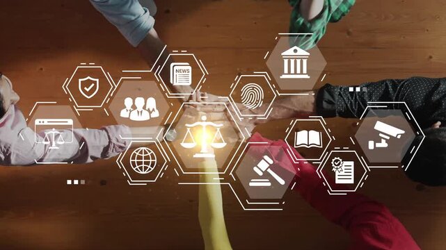 Hands of diverse people collaborating on technology and law concept with icons representing justice, information, security, and society on wooden table background Gluon.