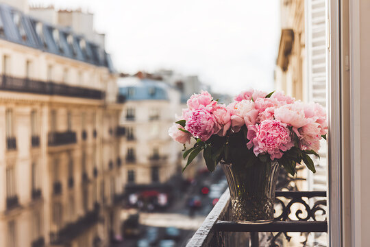 Beautiful Pink Flowers on a Parisian Balcony Overlooking Cityscape.