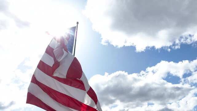 Close View of American Flag Flying in the Wind Against Sky