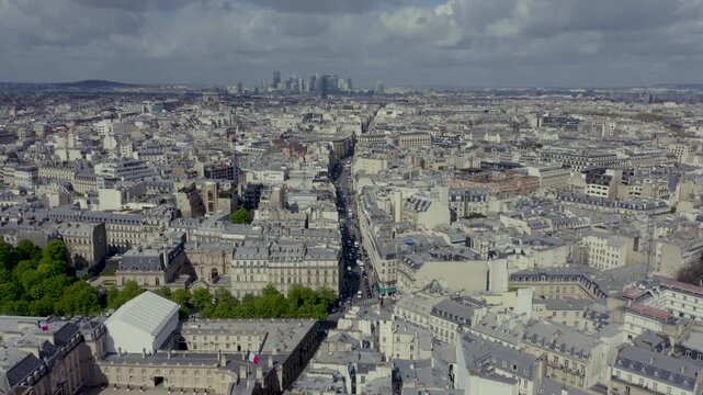 Aerial drone footage panorama of Paris city, shot under a partly cloudy sky. Elysee Palace in the foreground