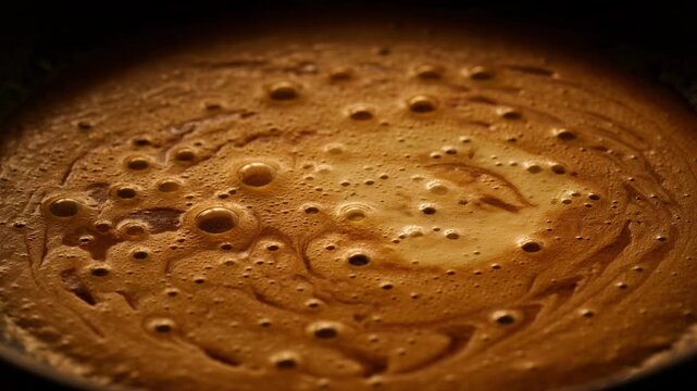 Extreme close up of fresh espresso crema surface texture