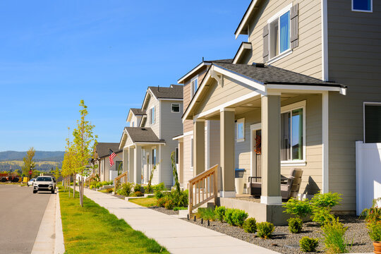 A modern residential street with townhome style homes in a planned community, with pedestrian friendly streets in an American suburb.
