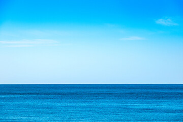 Fototapeta premium Tropical Nature clear sky and summer sea water under a clear blue sky with beautiful clouds and bright sunlight. Perfect for summer vacation and travel background 