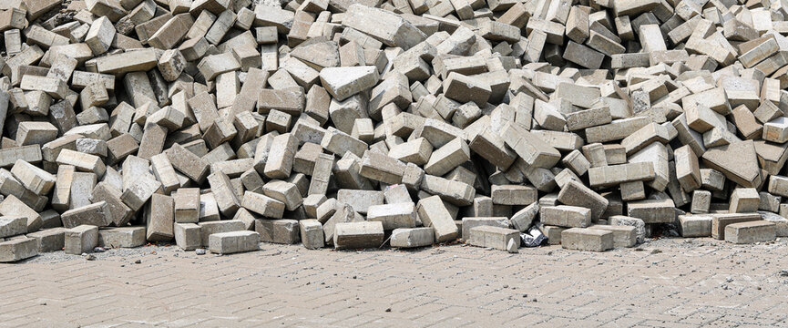 A large pile of grey concrete bricks at a construction site ready for building.